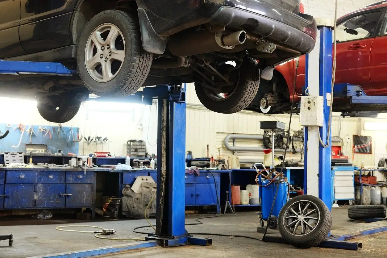 Vehicles on lifts in the Collision Icon repair shop